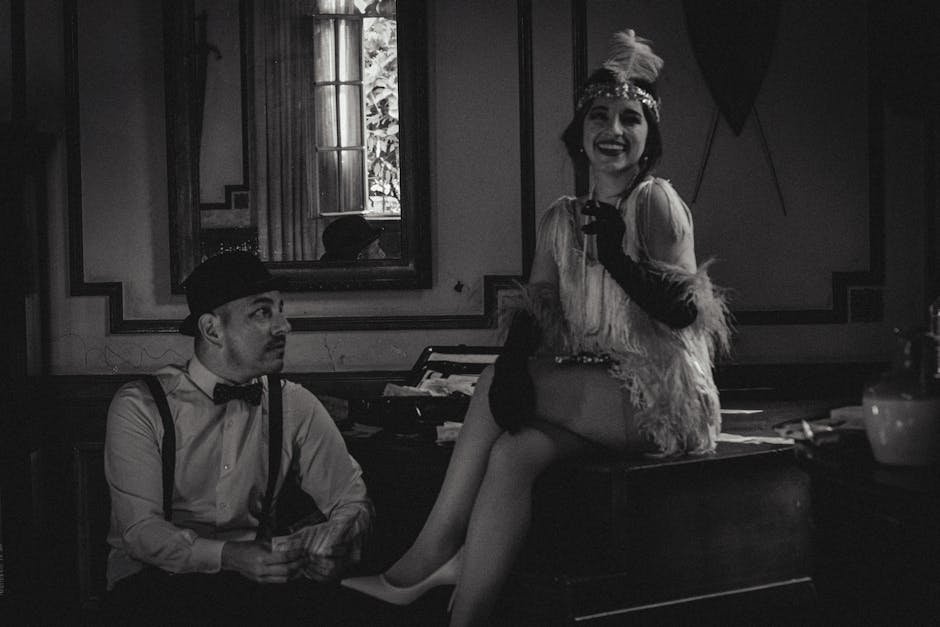 pexels-photo-24532507-24532507 Classic 1920s themed black and white photo featuring a stylish couple indoors.