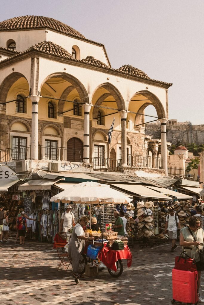 pexels-photo-28243336-28243336 Explore a bustling market in Athens, Greece, with traditional architecture and lively crowds.